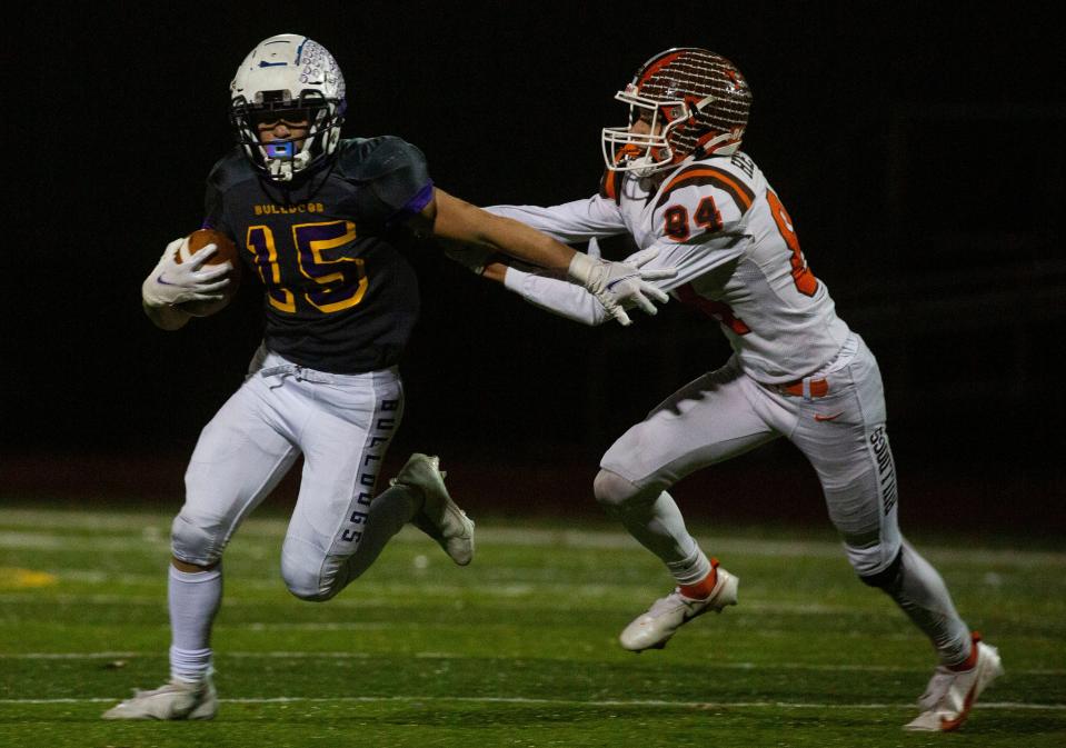 Bloom-Carroll's Dylan Armentrout evades a Heath defender during Friday night's Division IV, Region 15 semifinal at DeSales High School. Bloom-Carroll won, 35-6.