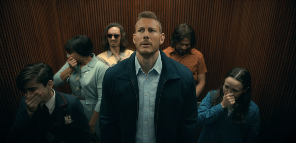 people covering their mouth in an elevator