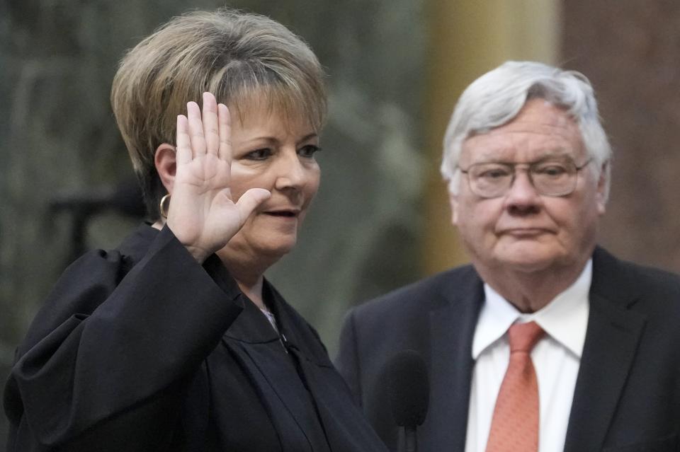 Janet Protasiewicz is sworn as a Wisconsin Supreme Court justice Tuesday, Aug. 1, 2023, in Madison, Wis. At right is Protasiewicz' husband Greg Sell. (AP Photo/Morry Gash)