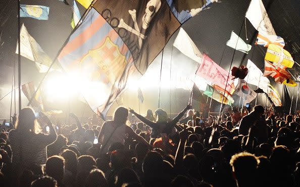 Revellers in front of the pyramid stage - Credit: Jim Dyson/Getty Images