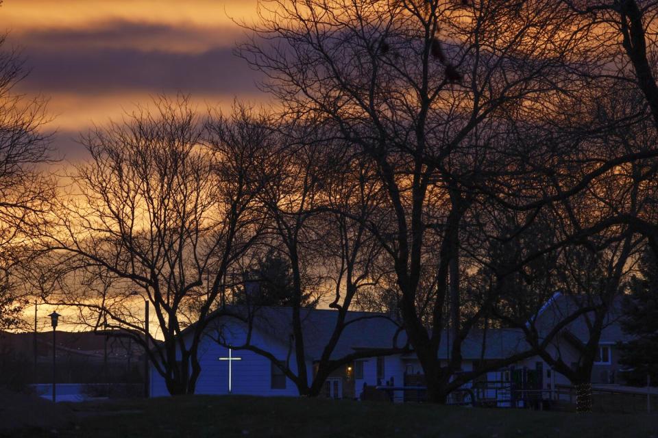 The early-morning sky glows red over the town of Colstrip.