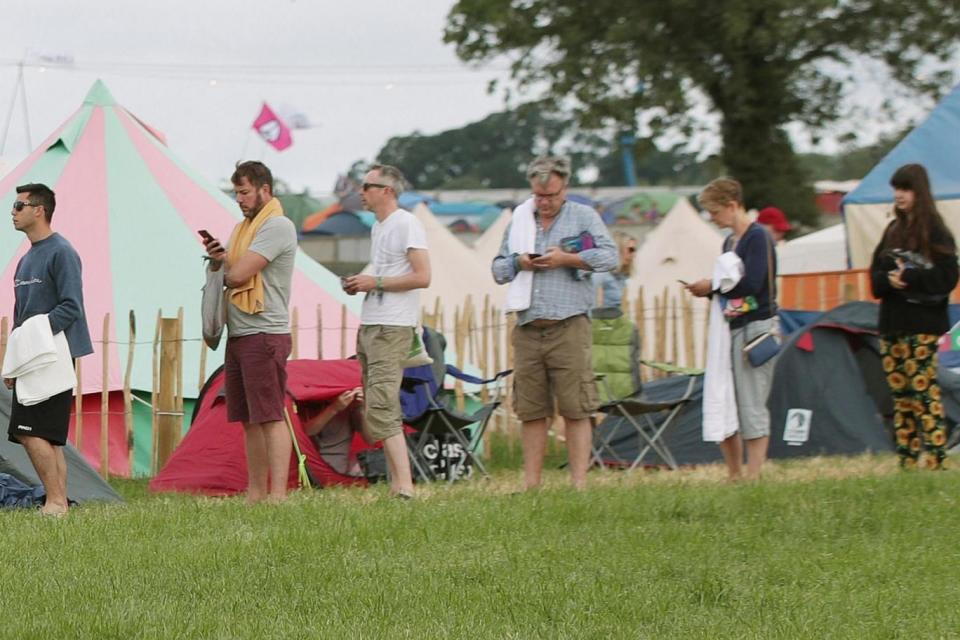 Glasto: Ed Balls (3rd right) and his wife Yvette Cooper (2nd right) waiting in a queue for the showers (PA)