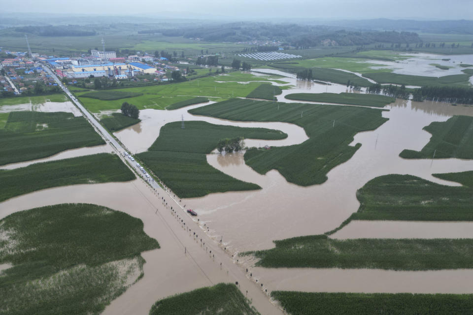 In this aerial photo released by Xinhua News Agency, flood waters course through fields and roads in Kaiyuan Town of Shulan in northeastern China's Jilin Province on Friday, Aug. 4, 2023. Northeastern China continued to be pelted by rain on Saturday, as authorities reported more deaths and missing people and evacuated thousands in the wake of Typhoon Doksuri. (Yan Linyun/Xinhua via AP)