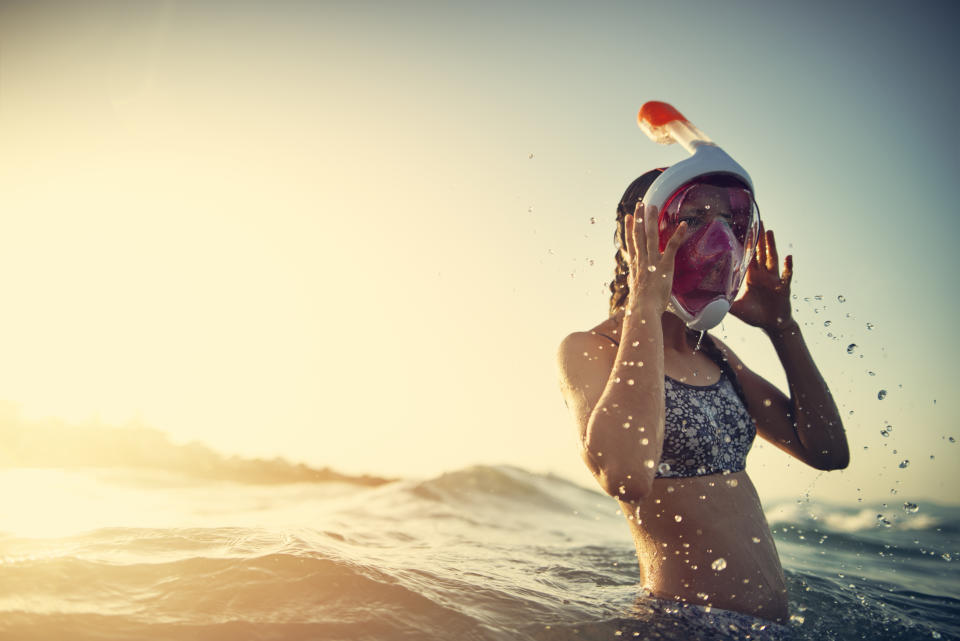 Teenage girl having fun at sea.