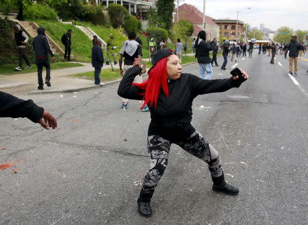 Demonstrators throw rocks at Baltimore police during clashes in Baltimore, Maryland April 27, 2015. REUTERS/Shannon Stapleton