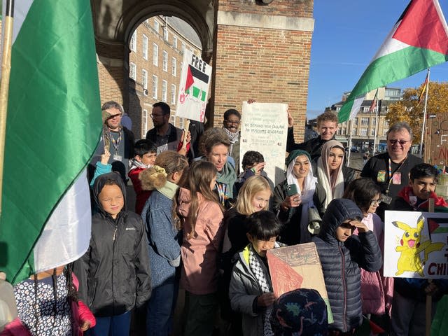 The school children were photographed with Ms Denyer following their protest (Claire Hayhurst/PA)