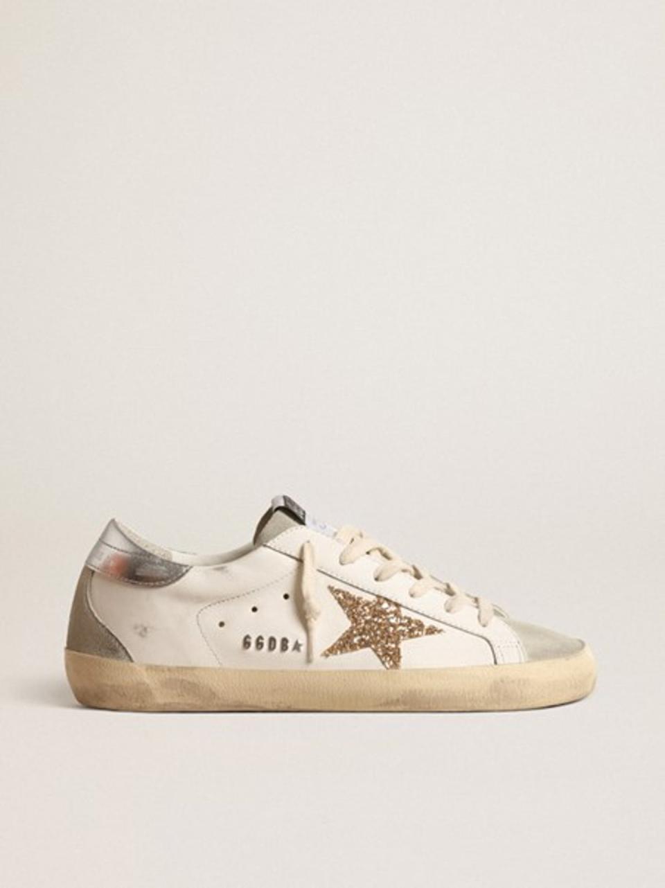 SUPER-STAR WITH GOLD GLITTER STAR AND ICE-GRAY SUEDE INSERTS, £440, GOLDENGOOSE.COM (G Goose)