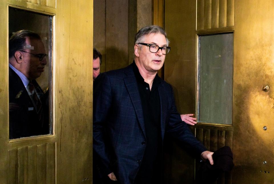 Actor Alec Baldwin (C) departs courtroom after a hearing at Manhattan Criminal Court