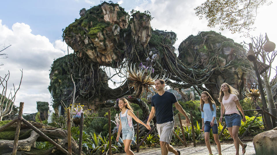 A family walking through Pandora -- The World of Avatar.