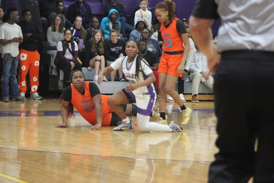 Johnson's Amayah Hamilton and Calvary Day's Bre Jones (on knee) after a scramble for a loose ball in Calvary's win on Jan. 26, 2024.