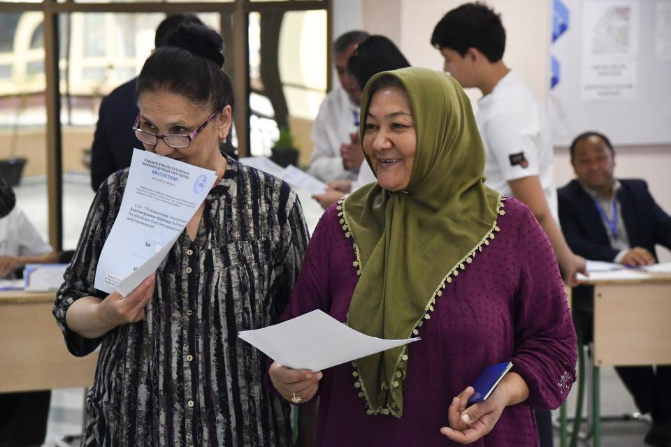 Two women walk to cast their ballots at a polling station during a referendum in Tashkent, Uzbekistan, Sunday, April 30, 2023. Voters in Uzbekistan are casting ballots in a referendum on a revised constitution that promises human rights reforms. But the reforms being voted on Sunday also would allow the country's president to stay in office until 2040. (AP Photo)