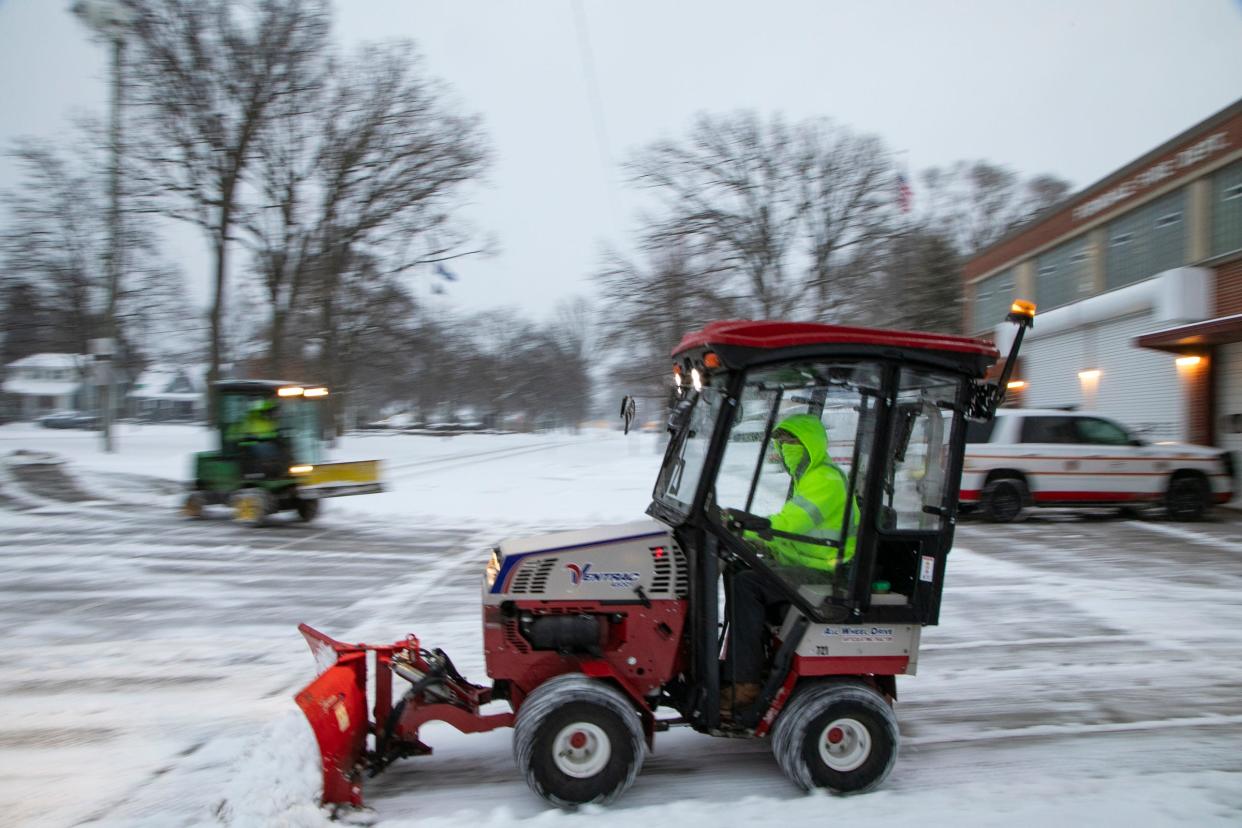 City of Ferndale workers plow snow away from the Ferndale Fire Department driveway early Tuesday, Jan. 26, 2021 after it snowed in the Metro Detroit area overnight.
