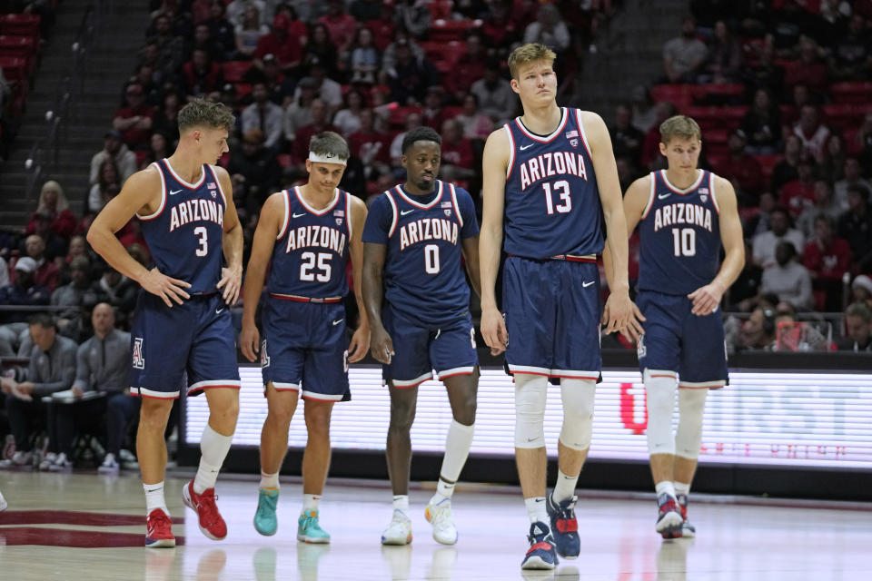 Arizona players walk on the court during the first half of the team's NCAA college basketball game against Utah on Thursday, Dec. 1, 2022, in Salt Lake City. (AP Photo/Rick Bowmer)