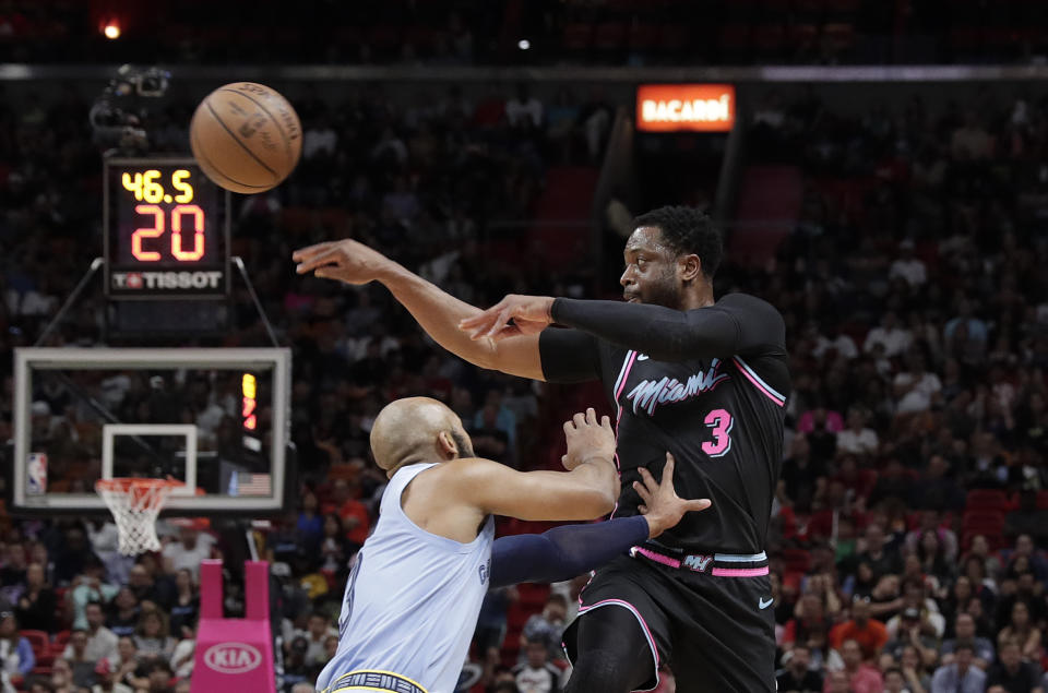 Miami Heat guard Dwyane Wade (3) passes the ball against Memphis Grizzlies guard Jevon Carter in the second half of an NBA basketball game Saturday, Jan. 12, 2019, in Miami. (AP Photo/Brynn Anderson)