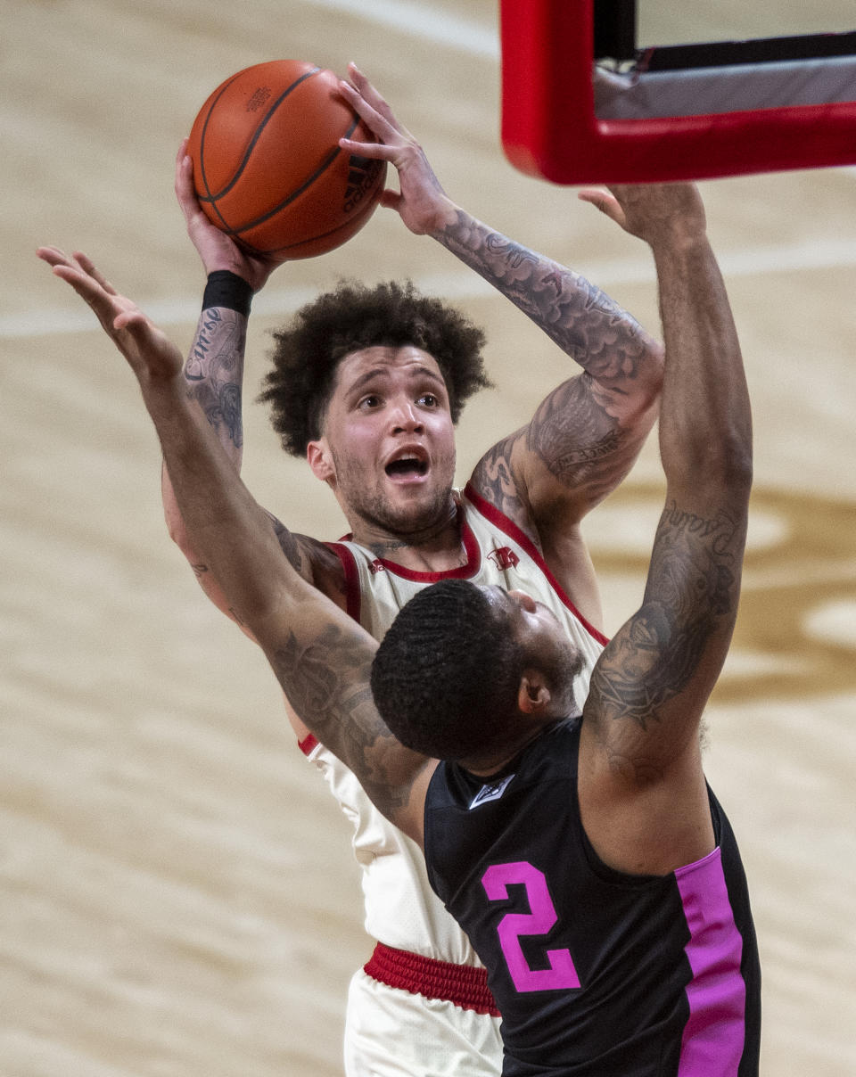 FILE - Nebraska guard Teddy Allen (0) drives to the basket against Penn State's Myles Dread (2) during the second half of an NCAA college basketball game in Lincoln, Neb., in this Tuesday, Feb. 23, 2021, file photo. Allen, who set the Pinnacle Bank Arena scoring record less than a week ago, left the Nebraska basketball team on Monday, March 1, 2021. Coach Fred Hoiberg and Allen released a joint statement announcing the departure and did not give a specific reason. (Francis Gardler/Lincoln Journal Star via AP, File)