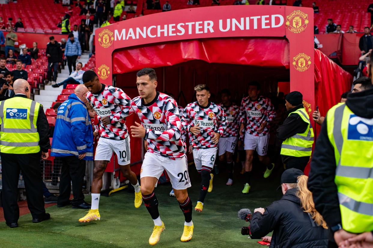 MANCHESTER, ENGLAND - AUGUST 22:  Diogo Dalot of Manchester United and team-mates run out to warm up prior to the Premier League match between Manchester United and Liverpool FC at Old Trafford on August 22, 2022 in Manchester, United Kingdom. (Photo by Ash Donelon/Manchester United via Getty Images)