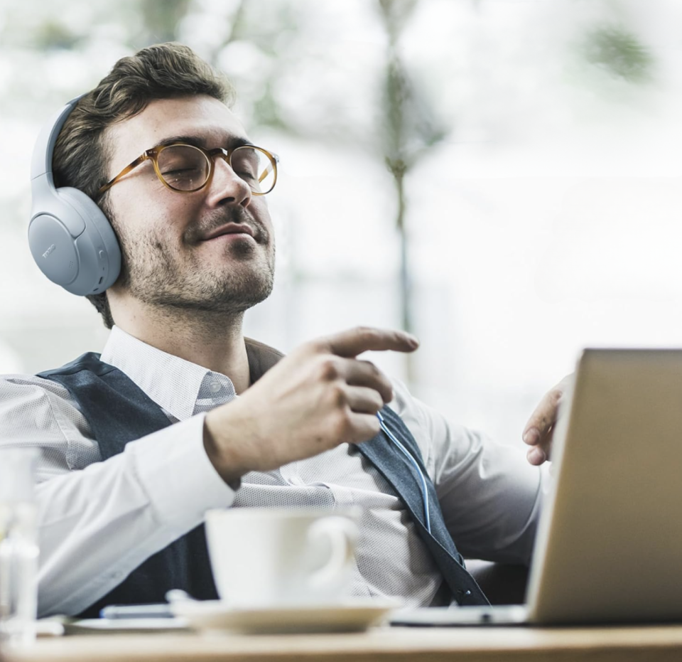 man listening to music in a coffee shop