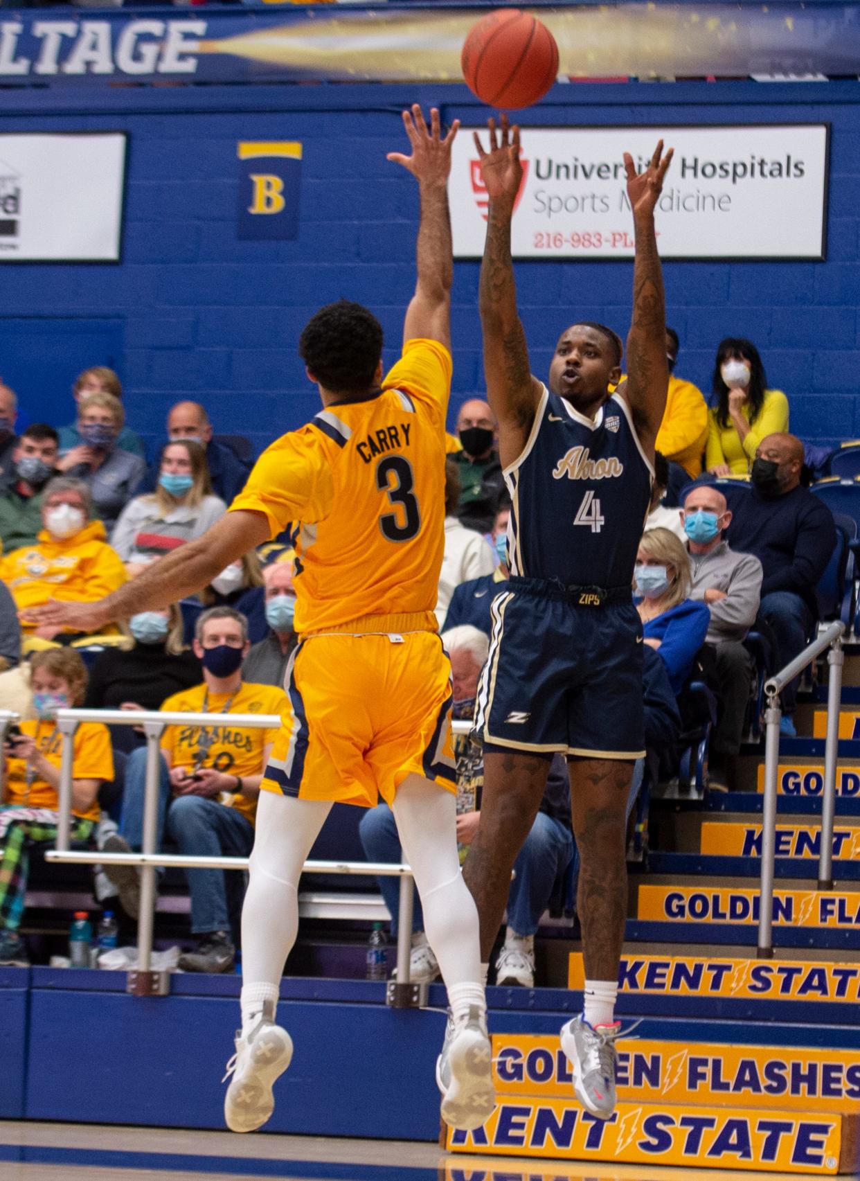 Kent State junior guard Sincere Carry defends a shot by Akron's Bryan Trimble Jr. during last Friday night's game at the M.A.C. Center.