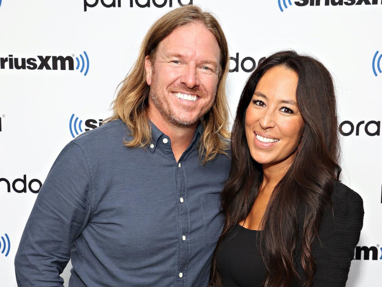 Chip and Joanna Gaines smile on a red carpet.