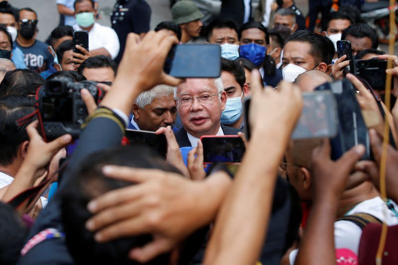 Former Malaysian Prime Minister Najib Razak speaks to journalists outside the Federal Court during a court break, in Putrajaya