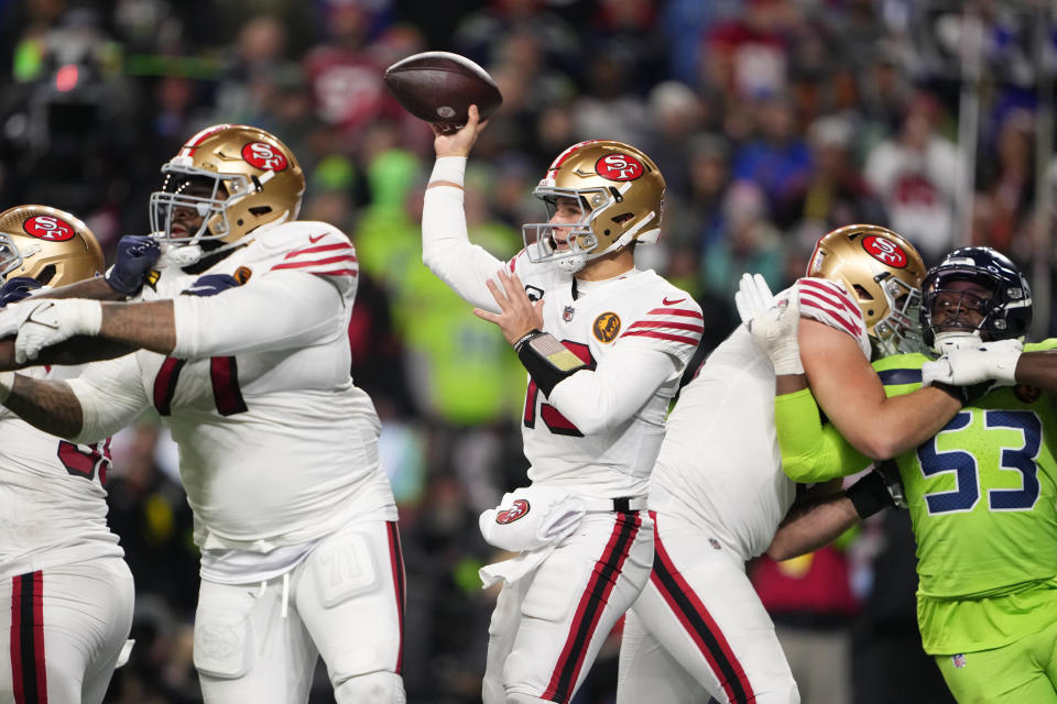 San Francisco 49ers quarterback Brock Purdy throws during the second half of an NFL football game against the Seattle Seahawks, Thursday, Nov. 23, 2023, in Seattle. (AP Photo/Lindsey Wasson)