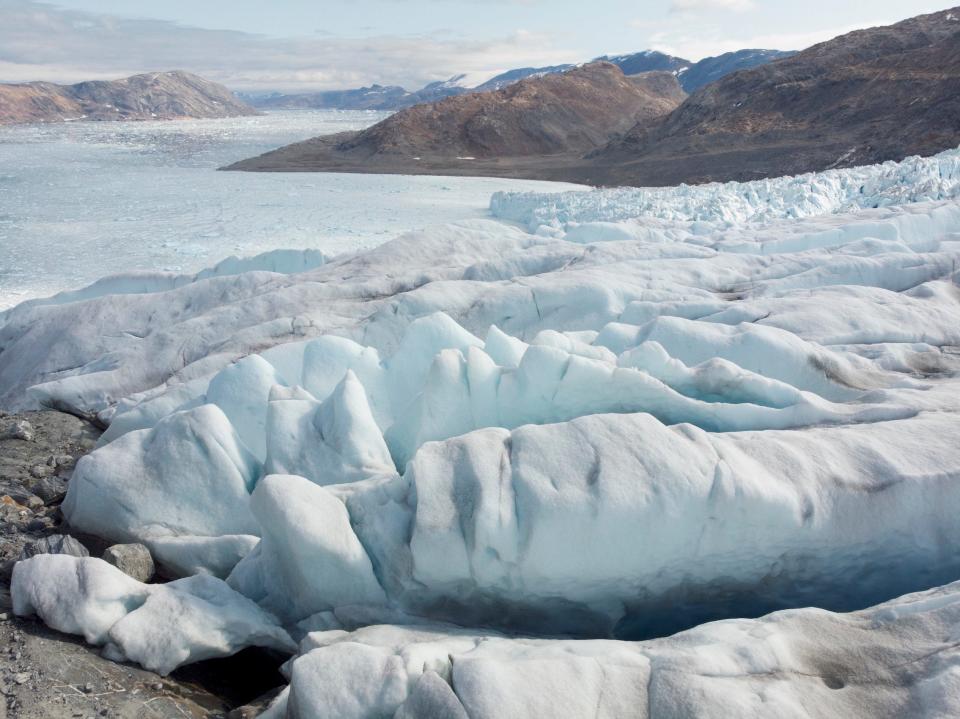 crevassed glacier with deep cracks dark grey with algae