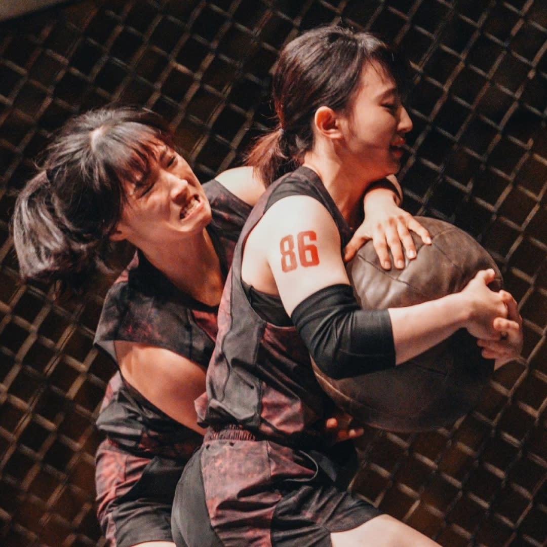  Two women (kim hye-bin and kim dam-bi) wrestle over a ball in an octagon, in 'physical 100' season 2. 