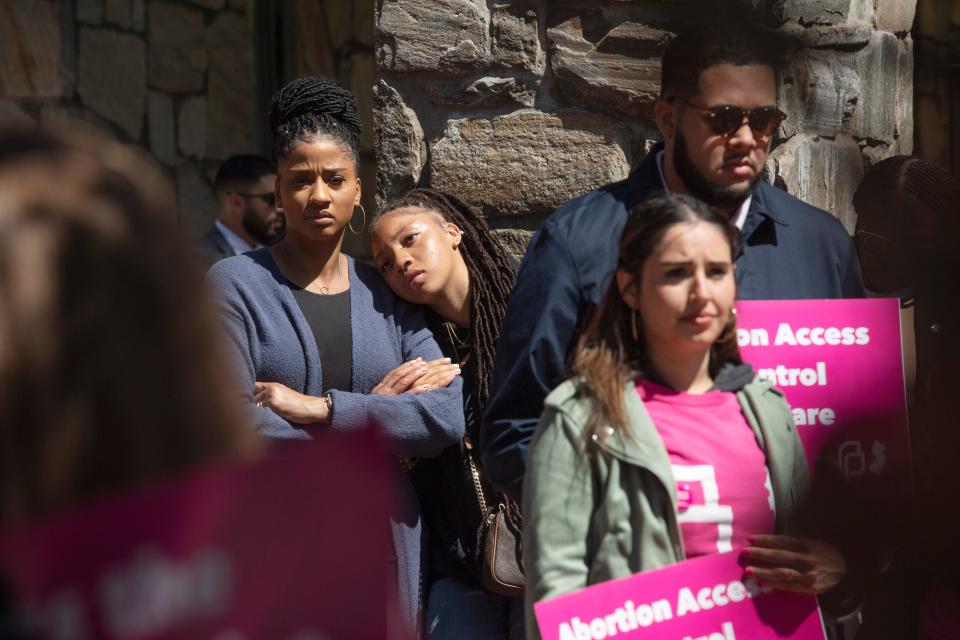 N.J. Assemblywoman Shanique Speight listens to speakers at the rally as her daughter, Madison, rests her head on her shoulder. The pro-Roe rally brought lawmakers and abortion rights activists to the Rutgers-Newark campus on Monday, May 9, 2022.