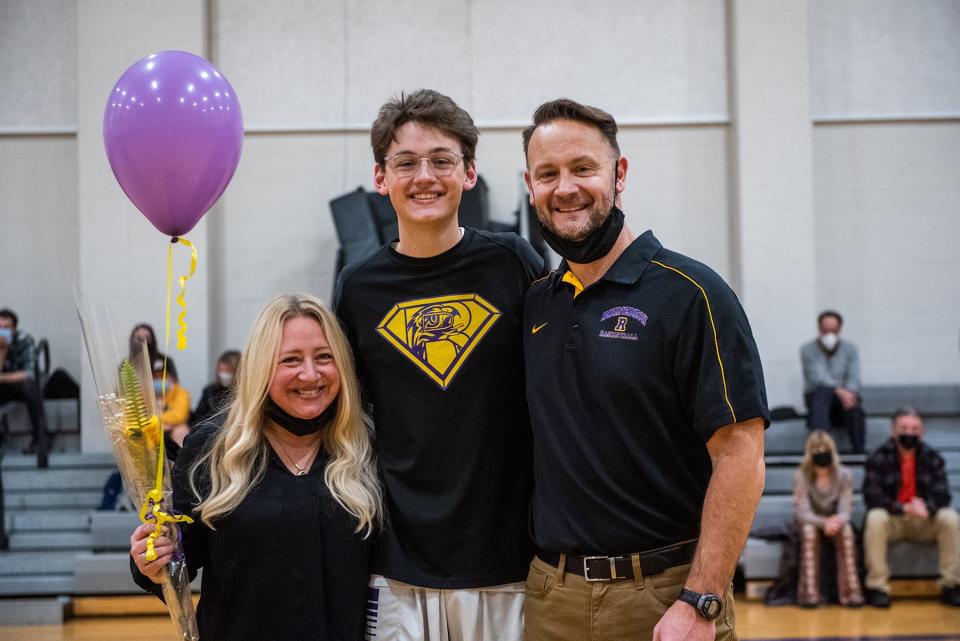 Rhinebeck's Bryce Aierstok stands with his parents on Senior Day before the Hawks boys basketball team defeated Onteora Friday in Rhinebeck.