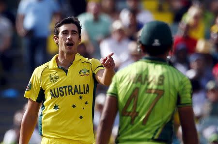 Australian bowler Mitchell Starc (L) speaks to Pakistan's batsman Wahab Riaz during their Cricket World Cup quarter final match in Adelaide, March 20, 2015. REUTERS/David Gray