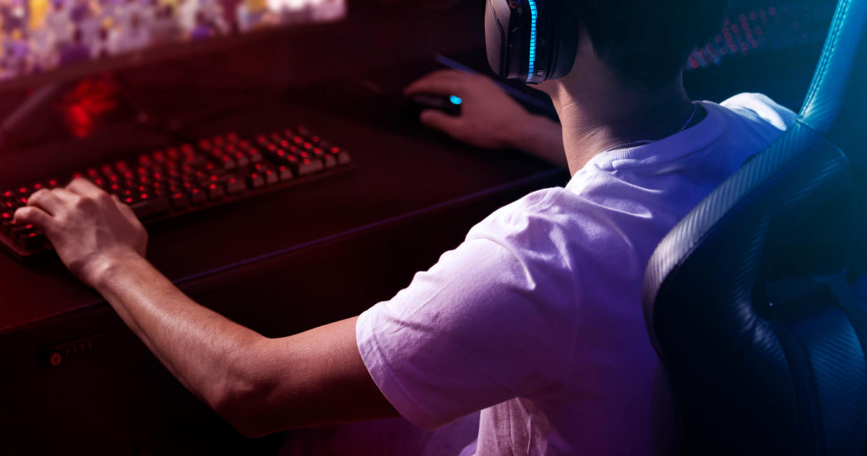 A gamer playing computer games on a keyboard and mouse. (Photo: Getty Images)