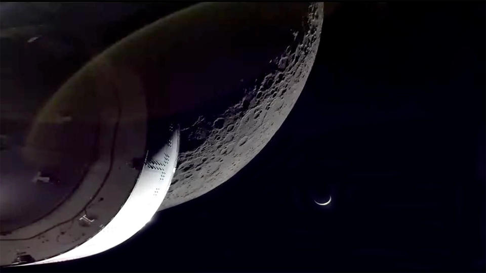 Moments after moving back into contact with flight controllers after a pass behind the moon, the Orion spacecraft beamed back live television shots of moon and Earth as the spacecraft headed for home (lens flare edited out for clarity). / Credit: NASA TV/CBS News