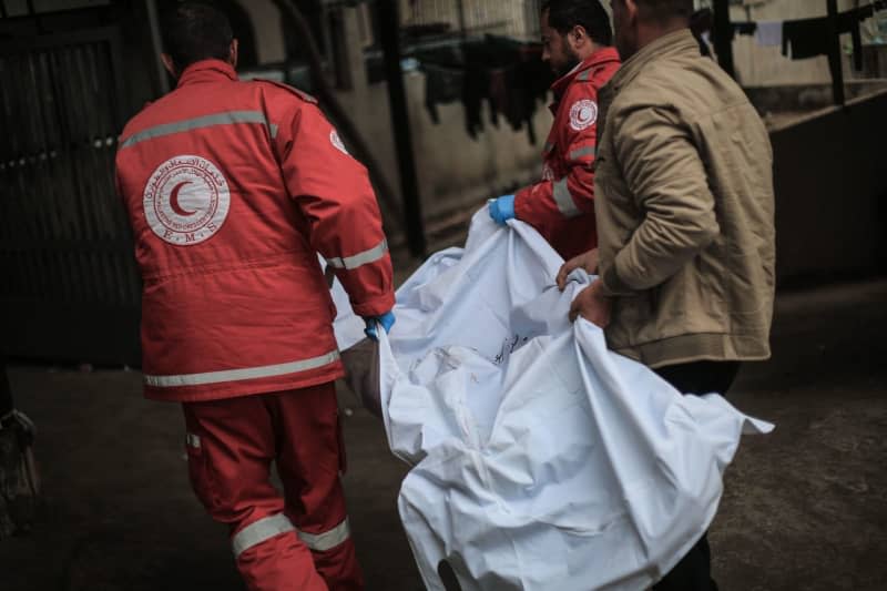 Palestinian paramedics carry the body of a Palestinian who was killed in Israeli airstrikes on the city of Rafah, at Al-Najjar Hospital. At least ten people were killed and others are missing under the rubble. Mohammed Talatene/dpa