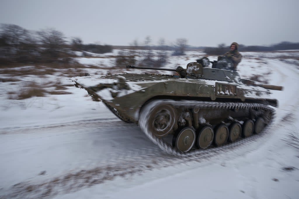 Ukrainians drive an armoured personnel carrier near a frontline position in the Luhansk area (Vadim Ghirda/AP) (AP)