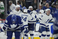 Tampa Bay Lightning players celebrate after defeating the Toronto Maple Leafs in Game 7 of an NHL hockey first-round playoff series in Toronto, Saturday, May 14, 2022. (Frank Gunn/The Canadian Press via AP)