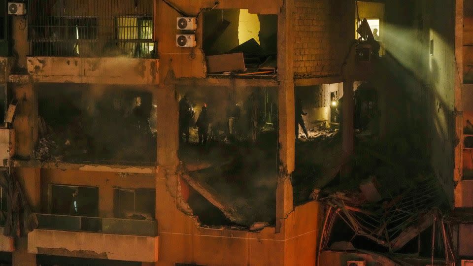 People search for survivors inside an apartment building following a massive explosion in a southern suburb of Beirut, Lebanon, on Jan. 2, 2024. - Hassan Ammar/AP