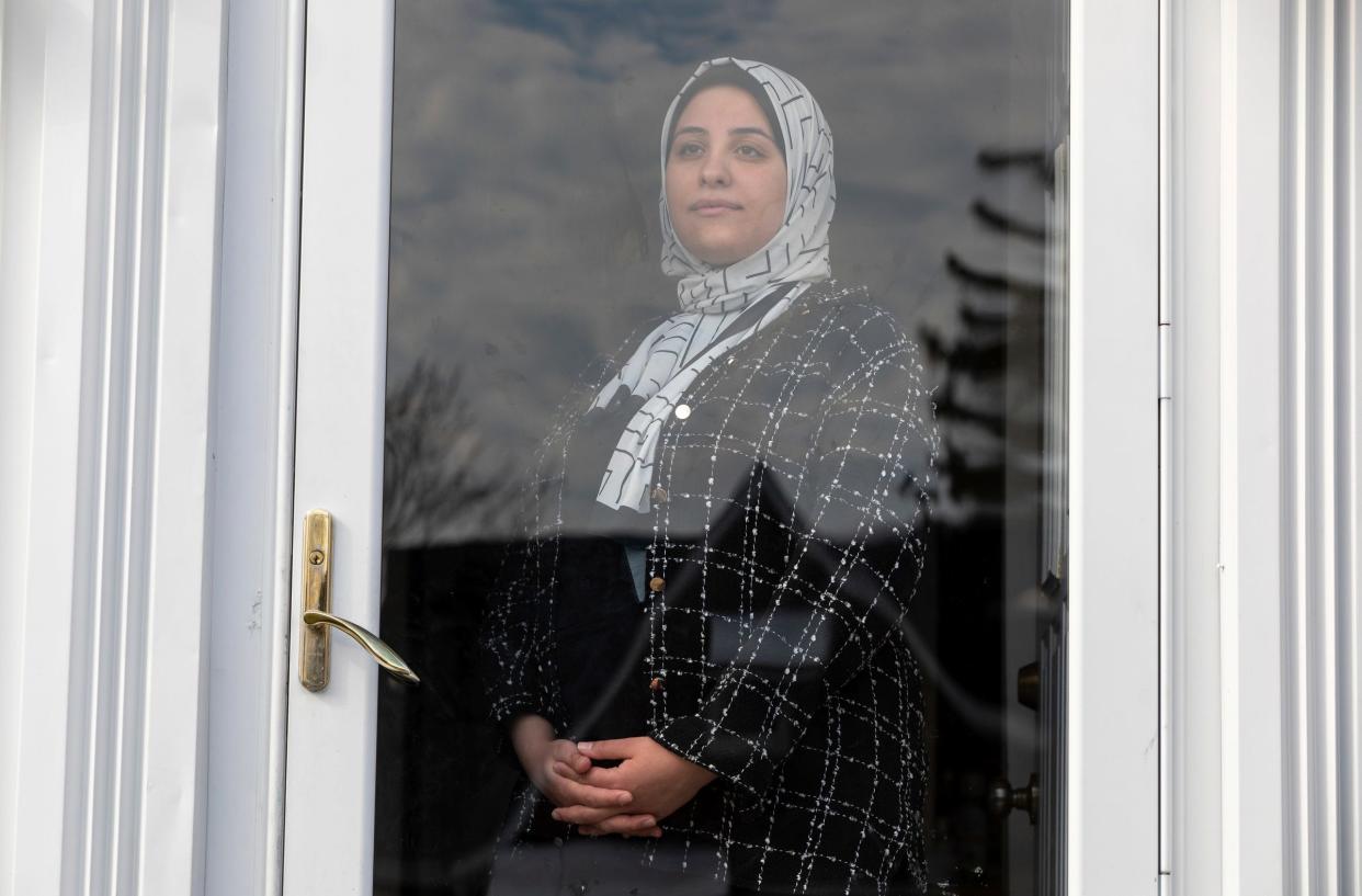 Sara Shannan, 27, stands at the entrance of her home early in the morning in Dearborn on Wednesday, Feb. 21, 2024. Shannan is trying to reunite her family in the US after they had to flee Gaza. She has launched a GoFundMe to help cover additional costs.