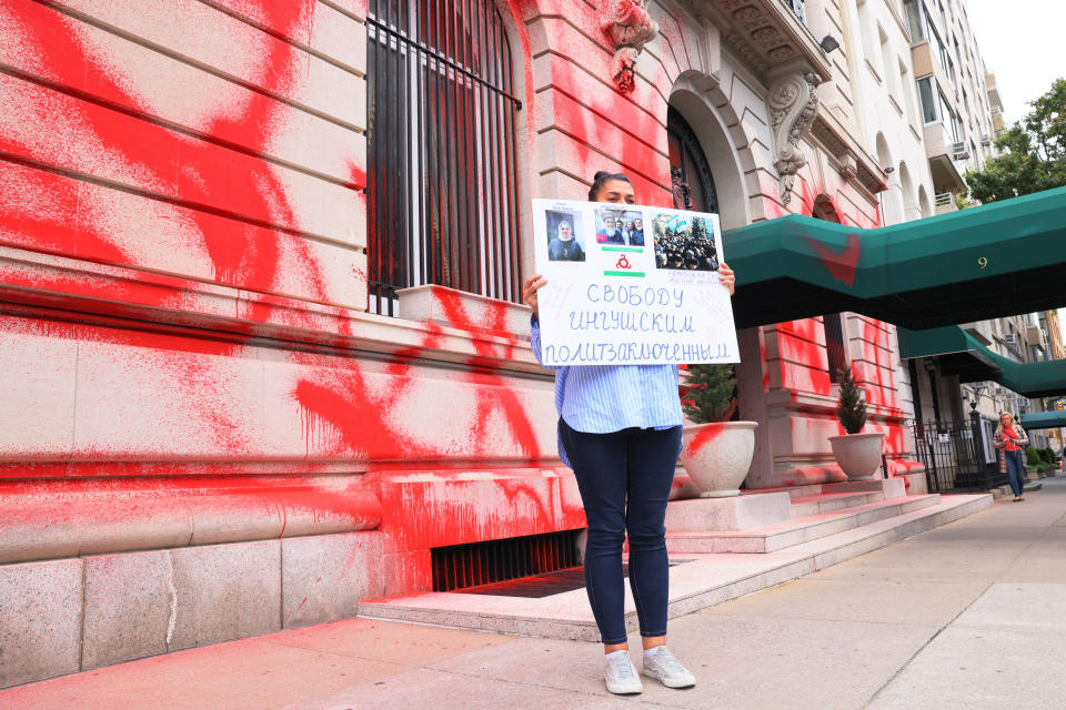 Tanzila Tumgoeva, from the Republic of Ingushetia, holds a protest sign as she stands in front of a vandalized Russian consulate on Sept. 30, 2022 in New York City. In a speech, Russian President Vladimir Putin proclaimed that four Ukrainian regions will be part of Russia and become Russian citizens forever.  / Credit: / Getty Images