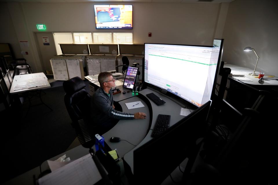 Tom Hanifin, New Bedford area dispatcher, hangs up after taking a new transformer call at the Eversource state-of-the-art control center at their facility in the New Bedford industrial park.
