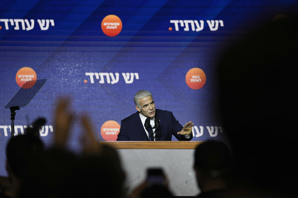 Israeli Prime Minister and the head of Yesh Atid party, Yair Lapid, speaks to his supporters after first exit poll results for the Israeli Parliamentary election at his party's headquarters in Tel Aviv, Israel, Wednesday, Nov. 2, 2022. (AP Photo/Ariel Schalit)