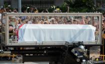 The body of Singapore's former prime minister Lee Kuan Yew is transferred atop a gun carriage from the Istana state complex to Parliament House where it will lie in state for public viewing ahead of his funeral, on March 25, 2015