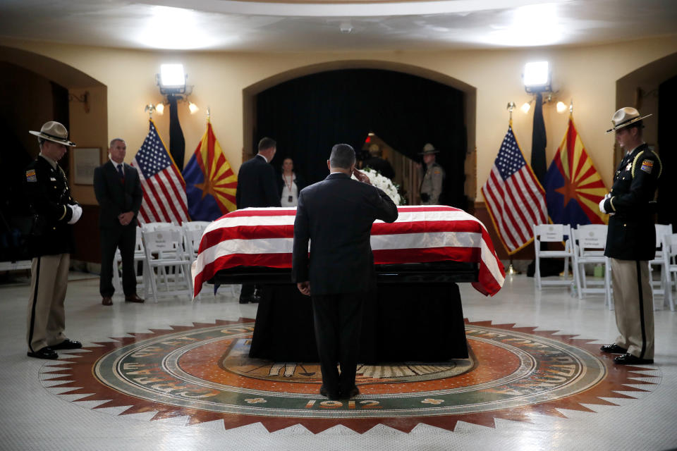 A serviceman salutes as he pays his respects at the casket of Sen. John McCain, R-Ariz. during a memorial service at the Arizona Capitol on Wednesday, Aug. 29, 2018, in Phoenix. (AP Photo/Jae C. Hong, Pool)