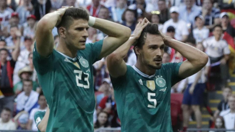 <p>German players Mario Gomez and Mats Hummels look stunned at the final whistle </p>