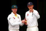 England's cricket team captain Joe Root gestures as he holds a replica Ashes urn with Australia's cricket team captain Steve Smith during an official event ahead of the Ashes opening test match at the GABBA ground in Brisbane, Australia, November 22, 2017. REUTERS/David Gray