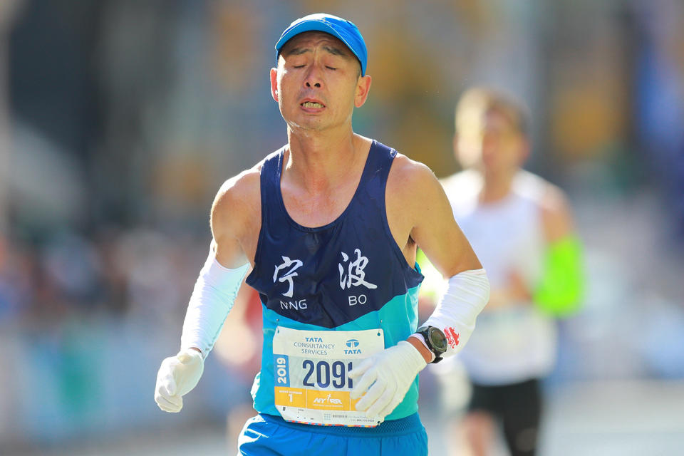 A runner tries to ignore the pain as reaches the 16th mile point of the 2019 New York City Marathon. (Photo: Gordon Donovan/Yahoo News)