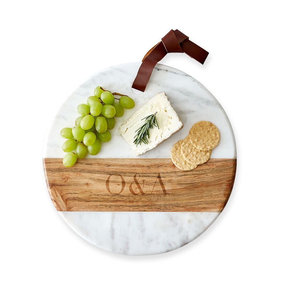 <p><a href="https://go.redirectingat.com?id=74968X1596630&url=https%3A%2F%2Fwww.markandgraham.com%2Fproducts%2Fmonogrammed-wood-marble-cheese-board-round%2F&sref=https%3A%2F%2Fwww.elle.com%2Ffashion%2Fshopping%2Fg60113581%2Fbest-gifts-under-100%2F" rel="nofollow noopener" target="_blank" data-ylk="slk:Shop Now;elm:context_link;itc:0;sec:content-canvas" class="link rapid-noclick-resp">Shop Now</a></p><p>Wood and Marble Round Cheese Board</p><p>Mark and Graham</p><p>$59.00</p>