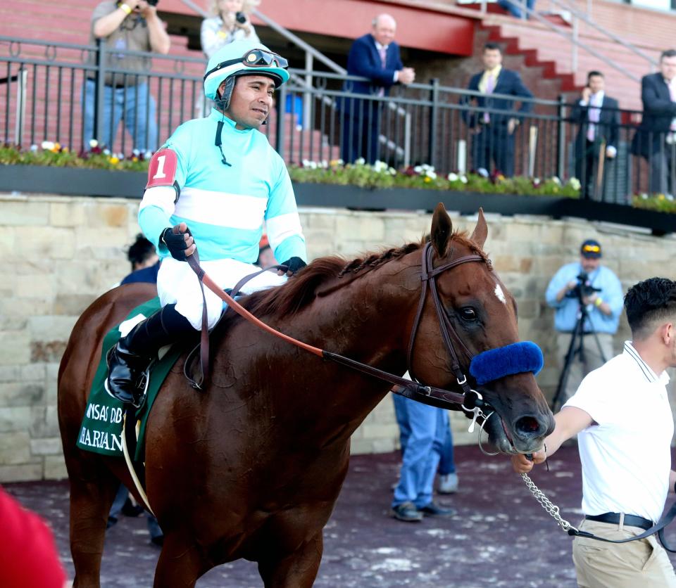 Martin Garcia, top, and Charlatan head into the Winner's Circle after winning the first division of the Arkansas Derby horse race Saturday, May 2, 2020, at Oaklawn Racing Casino Resort in Hot Springs, Ark. (Richard Rasmussen/The Sentinel-Record via AP)