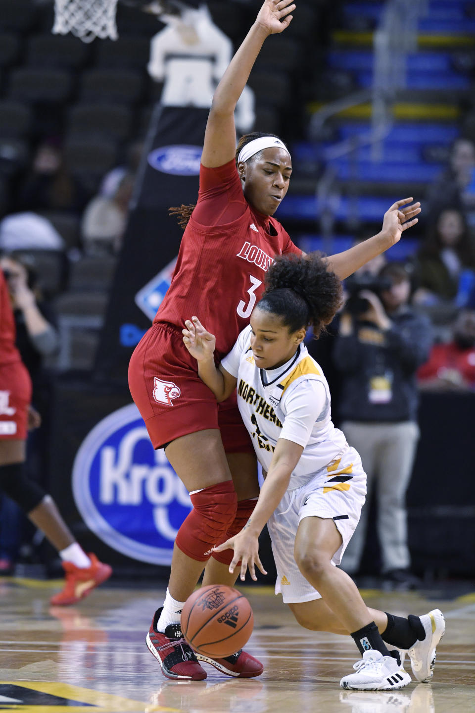 Northern Kentucky guard Ivy Turner (2) tries to fight through the defense of Louisville forward Bionca Dunham (33) during the second half of an NCAA college basketball game in Highland Heights, Ky., Sunday, Dec. 8, 2019. Louisville won 85-57. (AP Photo/Timothy D. Easley)