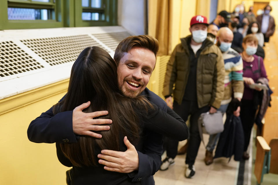 Rep. Alexandria Ocasio-Cortez, D-N.Y., left, is given a hug by a supporter as she meets with constituents after her monthly town hall for District NY-14 in the Astoria neighborhood of the Queens borough in New York, Wednesday, April 20, 2022. As she seeks a third term this year and navigates the implications of being celebrity in her own right, she's determined to avoid any suggestion that she is losing touch with her constituents. (AP Photo/John Minchillo)