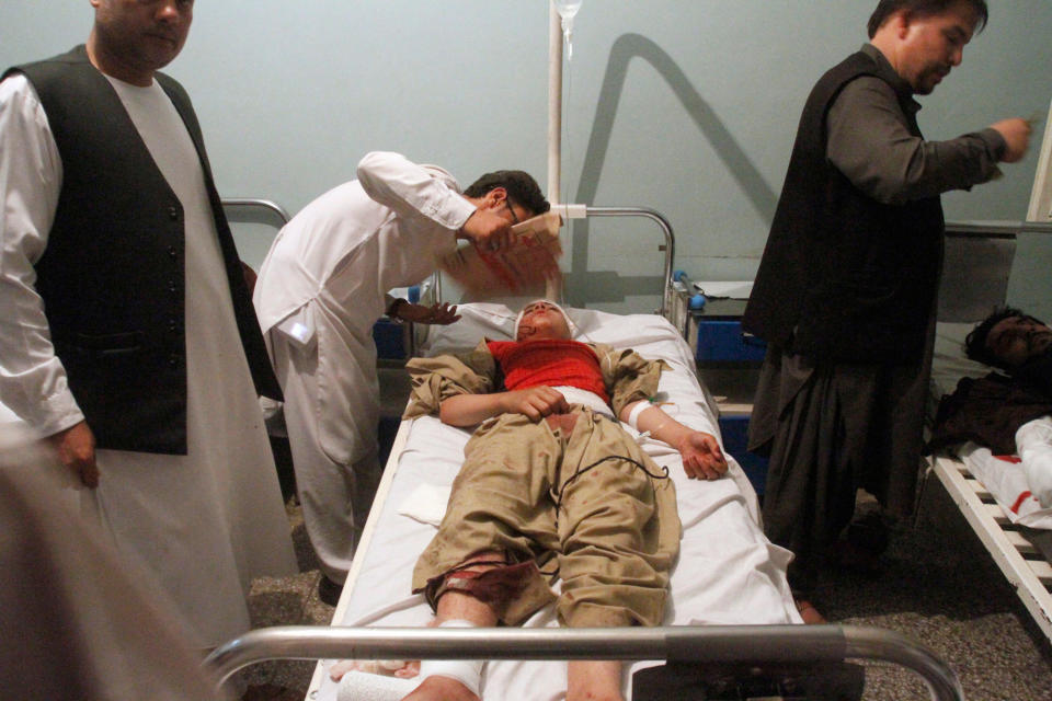 <p>Relatives assist a wounded man in a hospital after a suicide attack on a mosque in Herat, Afghanistan, Tuesday, Aug. 1, 2017. An Afghan hospital official says an explosion inside a minority Shiite mosque in western Herat, on the border with Iran, has killed at least 20 people. (Photo: Hamed Sarfarazi/AP) </p>